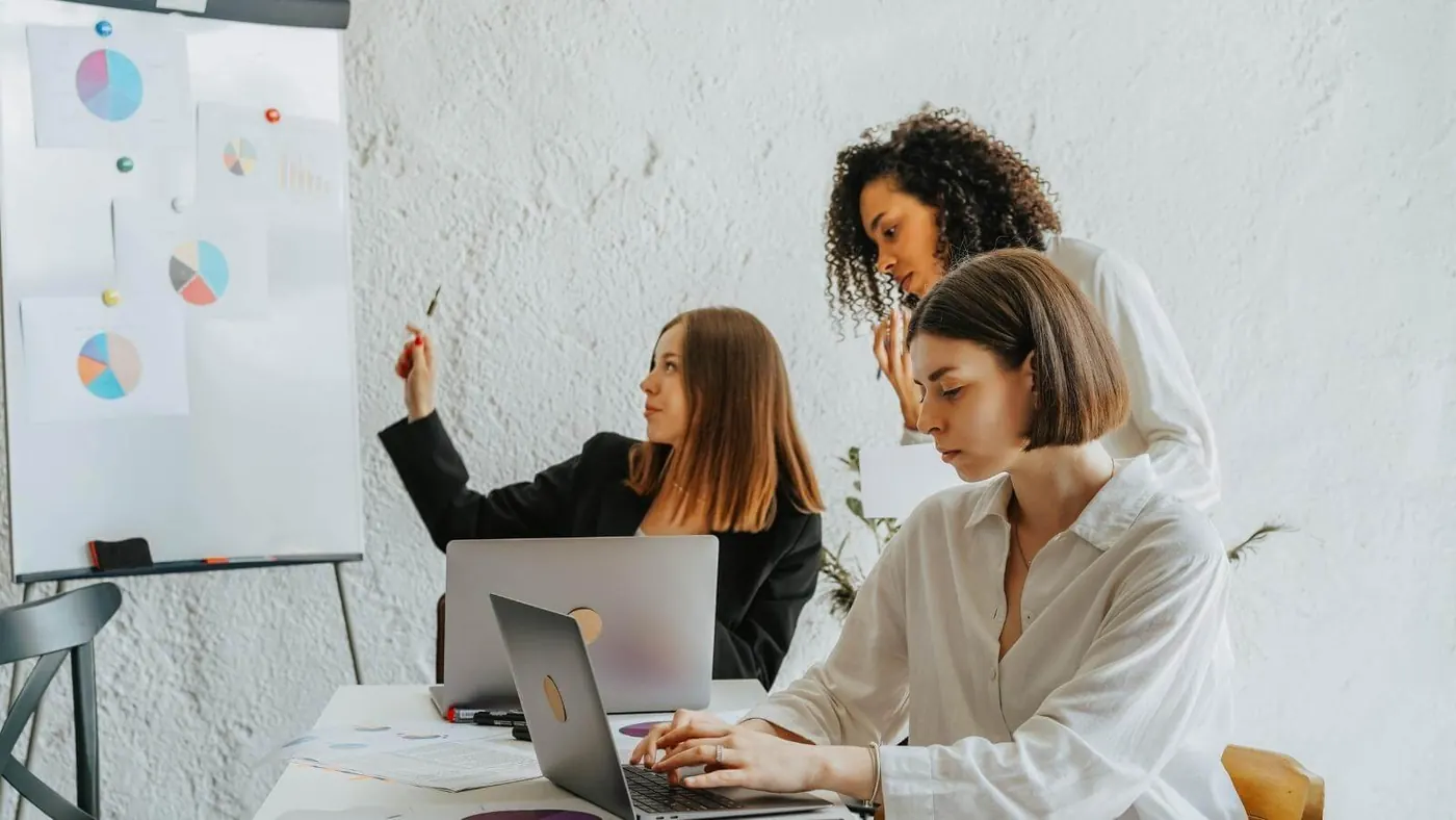 group of women meeting and looking at charts