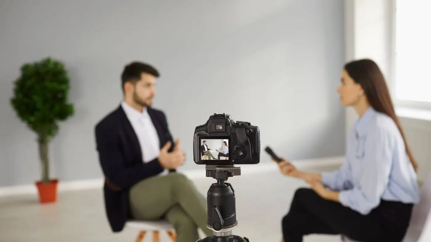 Man and woman conducting a recorded interview