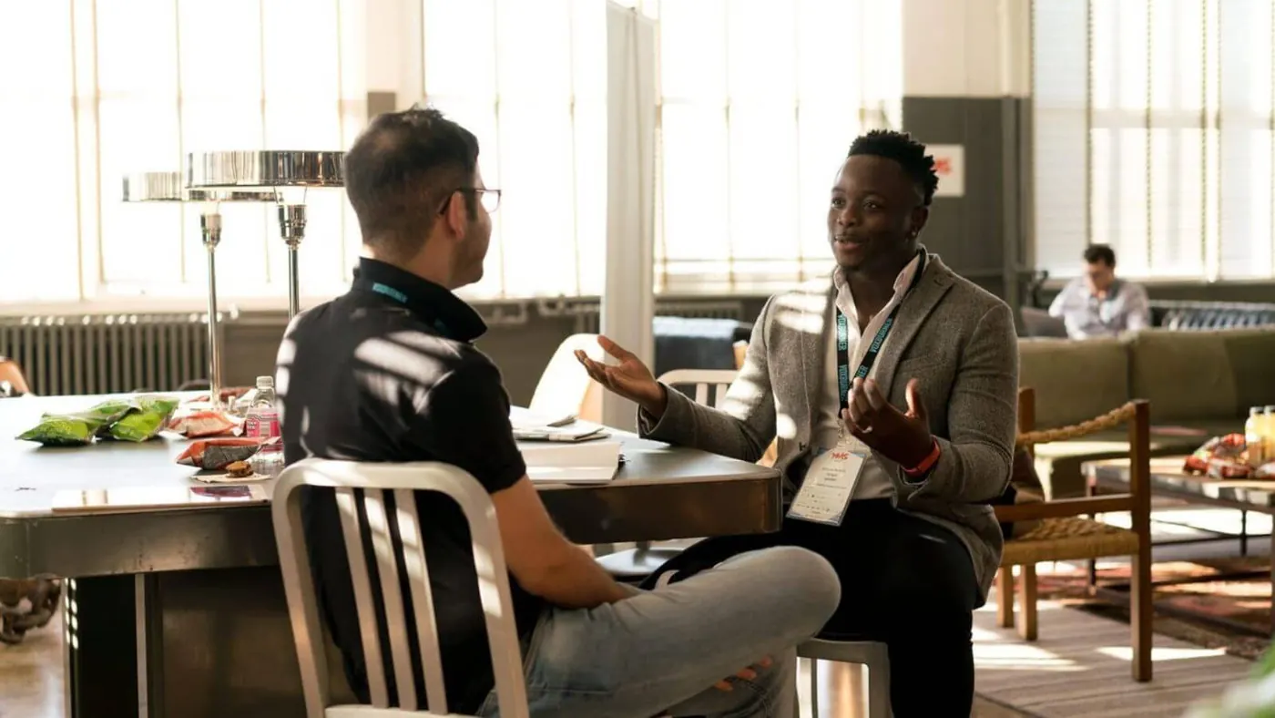 two men speaking at an event