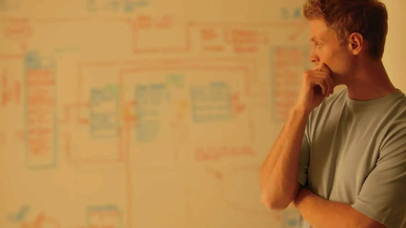Man looking at whiteboard. 