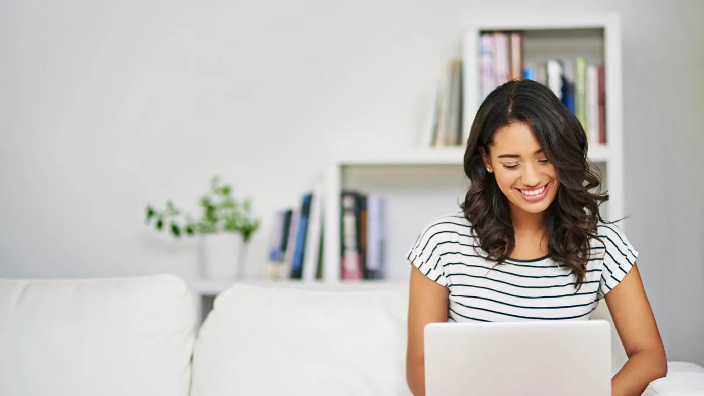 Woman smiling at laptop computer