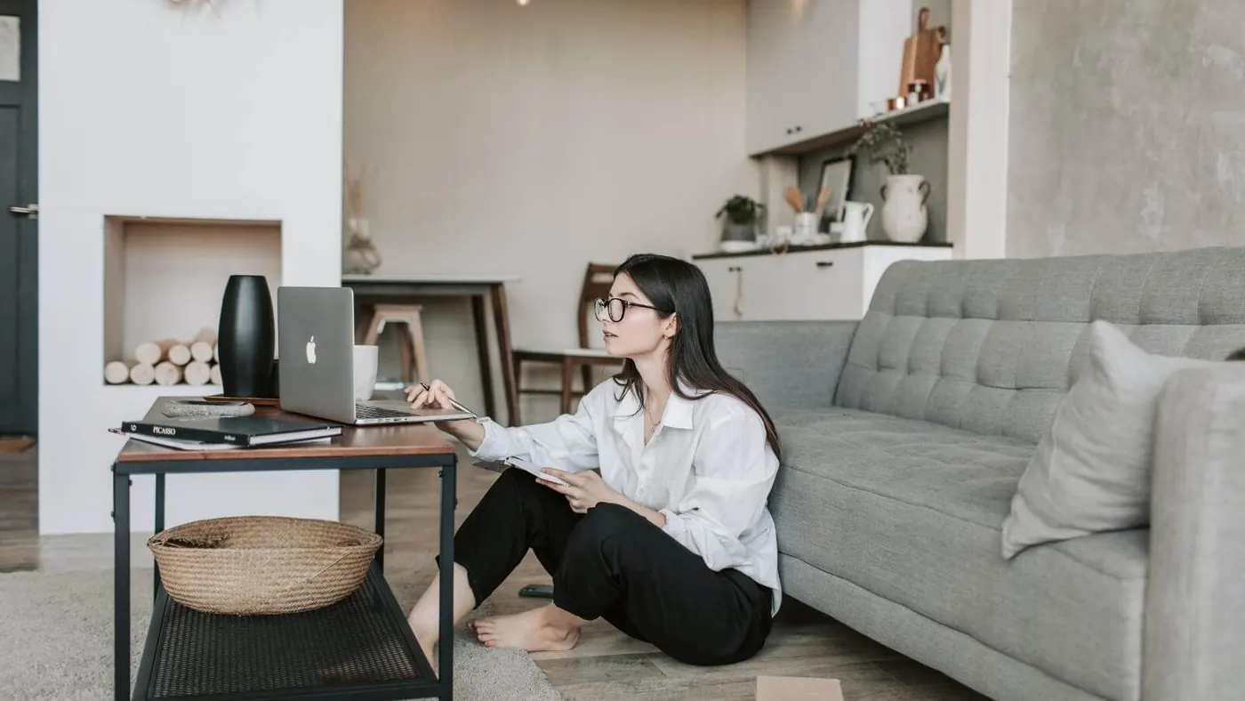woman-sitting-on-the-floor-while-using-her-laptop