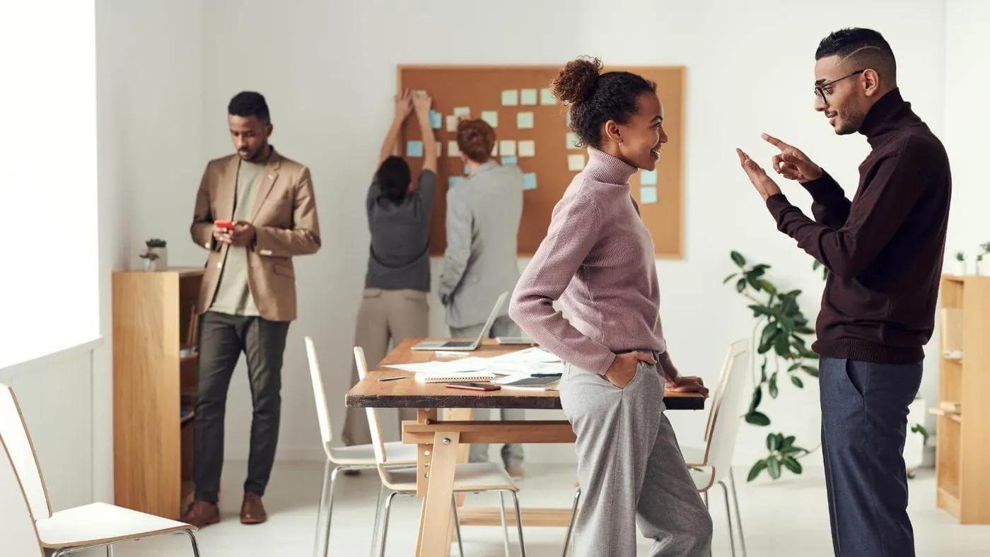 coworkers talking during a meeting break