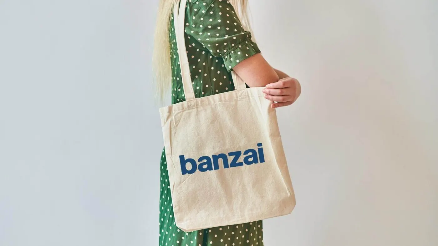 person carrying tote bag with Banzai logo