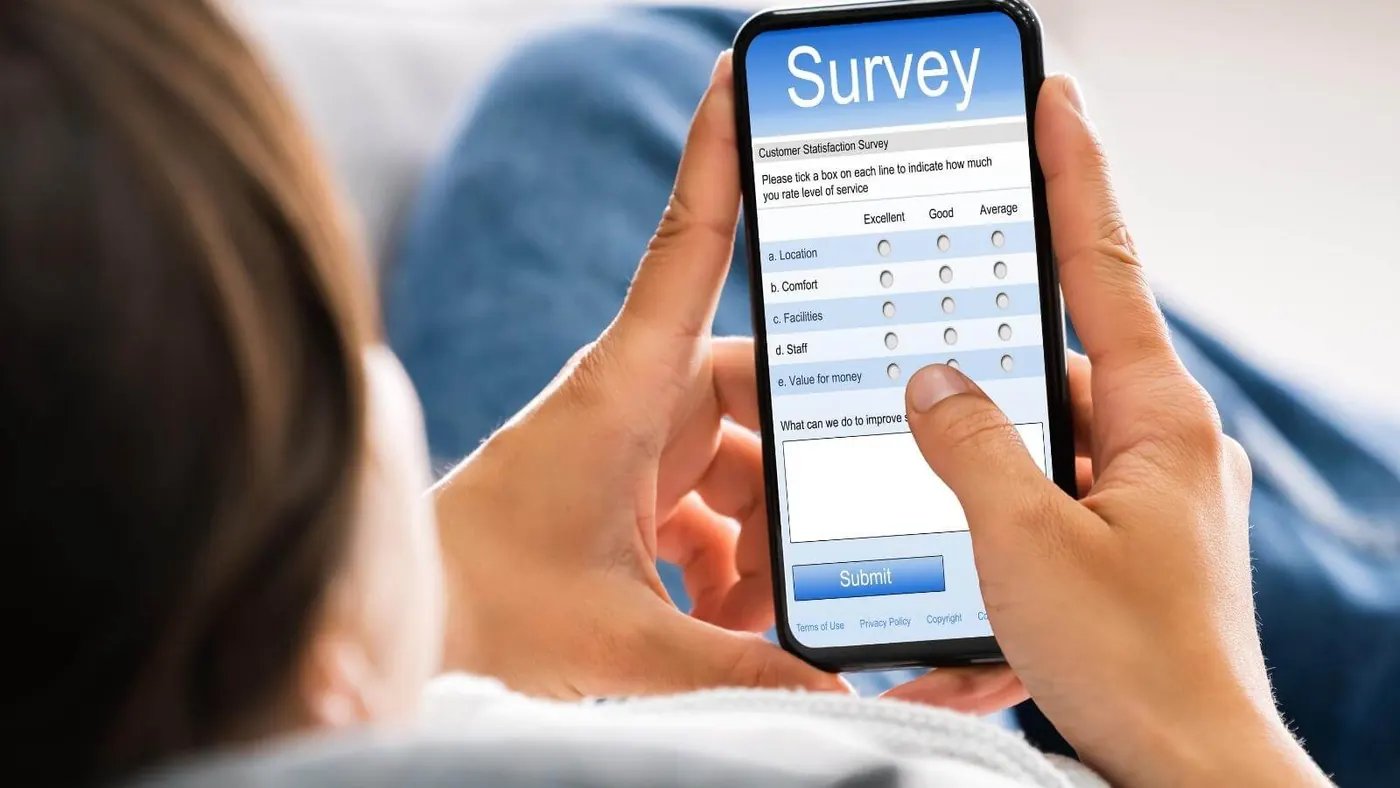 Woman taking event survey on phone